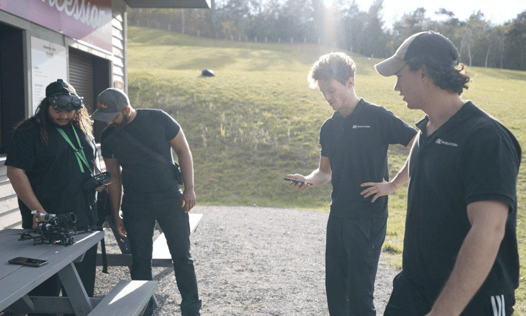 4 men in black shirts