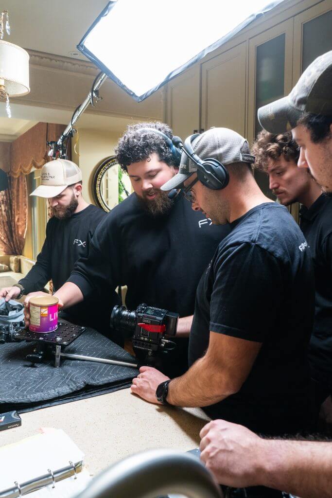 FX Productions Canada A Toronto Video Production crew arranges equipment and a camera around a jar of peanut butter on a kitchen counter, preparing for a shoot under studio lighting. Toronto Video Production Company