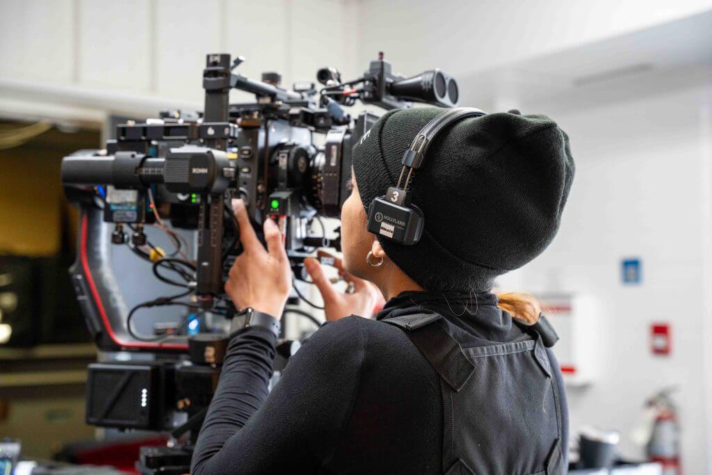 FX Productions Canada A person wearing a black beanie and headset operates a professional video camera indoors for FX Productions Canada, a leading Toronto Video Production company. Toronto Video Production Company