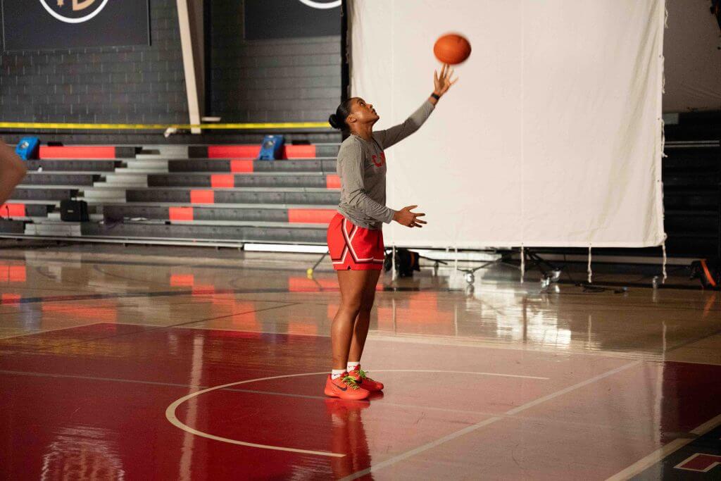 FX Productions Canada A basketball player in red shorts and a gray shirt prepares to shoot the ball in an indoor gym with bleachers—captured by FX Productions Canada, a leading Toronto Video Production team. Toronto Video Production Company