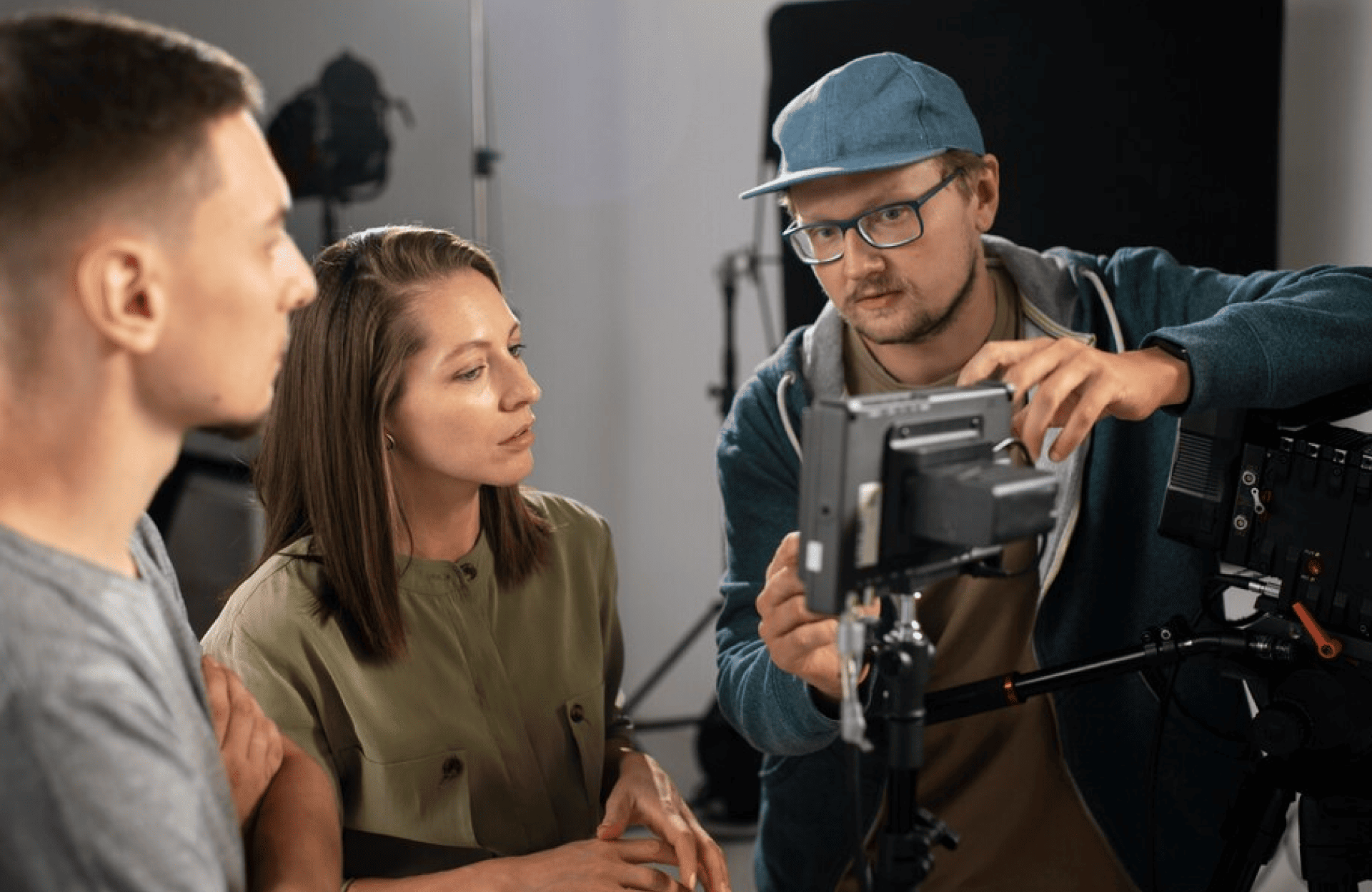 FX Productions Canada Three people stand next to camera equipment as one of them, wearing a blue cap, adjusts a monitor while others observe—a glimpse behind the scenes with FX Productions Canada, a leading Toronto Production Company. Toronto Video Production Company