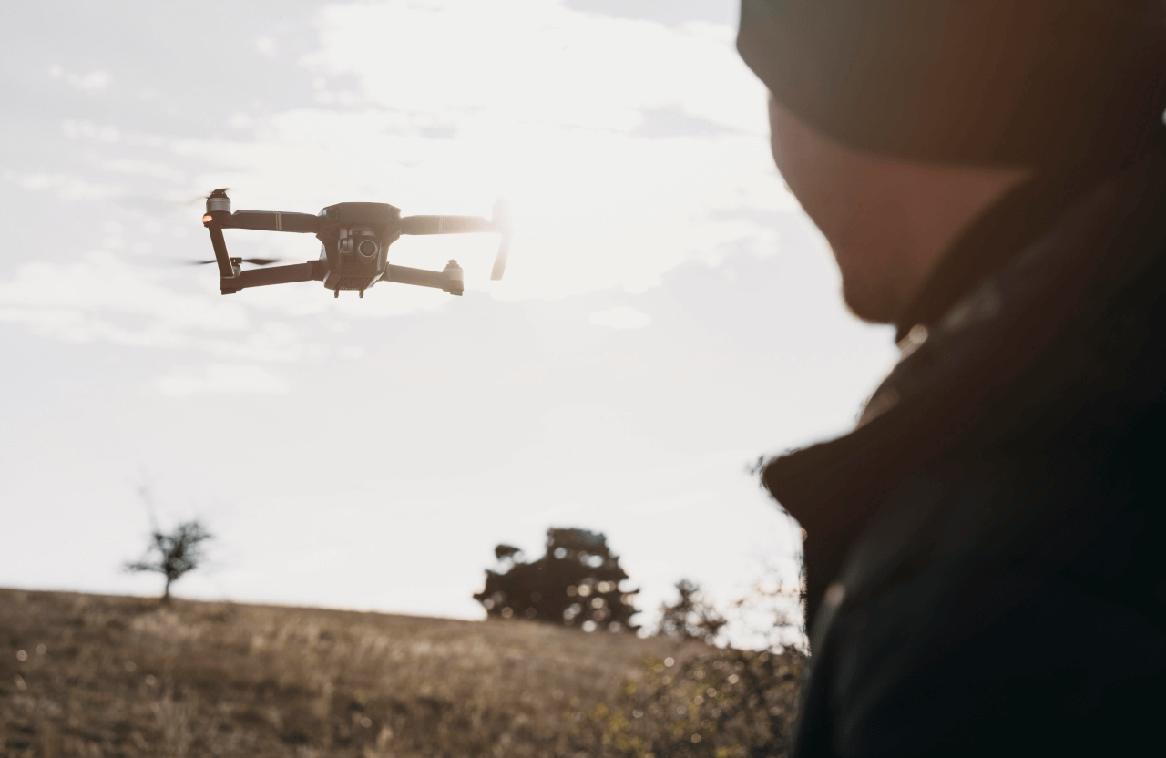FX Productions Canada A person operates a drone in an open field during daylight, with the drone hovering in mid-air and the sun shining in the background—an ideal scene for FX Productions Canada, a leading Toronto production company. Toronto Video Production Company