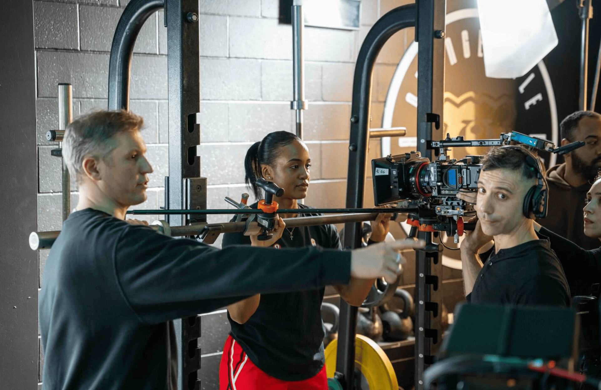 FX Productions Canada A Toronto Production Company crew adjusts camera equipment inside a gym, with one person pointing as others prepare to shoot a scene. Toronto Video Production Company