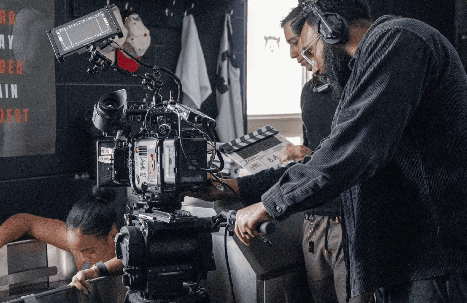 FX Productions Canada A film crew operates a camera and clapperboard while a woman leans over a tub, preparing to shoot a scene on a movie set. Toronto Video Production Company
