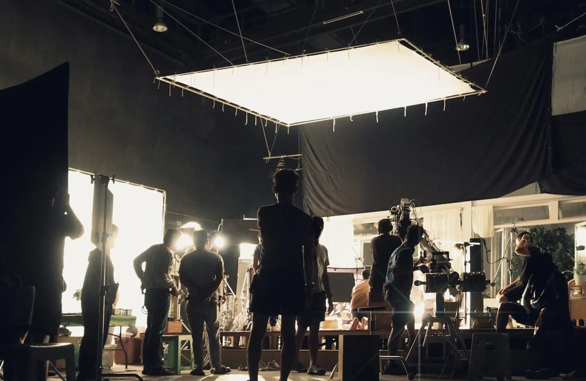 FX Productions Canada A film crew is gathered on a studio set with lighting equipment, cameras, and crew members actively preparing for a shoot. Toronto Video Production Company