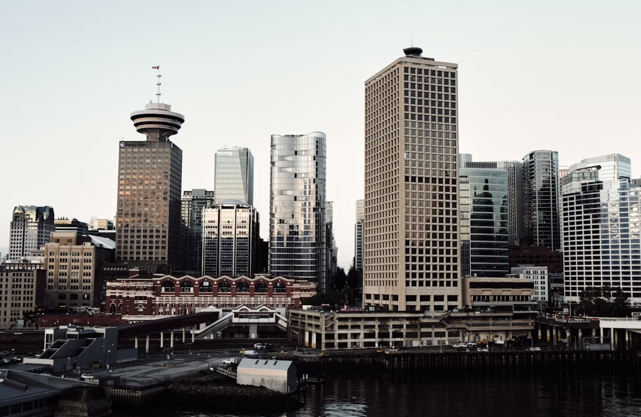 FX Productions Canada A city skyline featuring modern and older buildings by the waterfront under a clear sky—a scene often captured by leading video production companies Toronto. Toronto Video Production Company