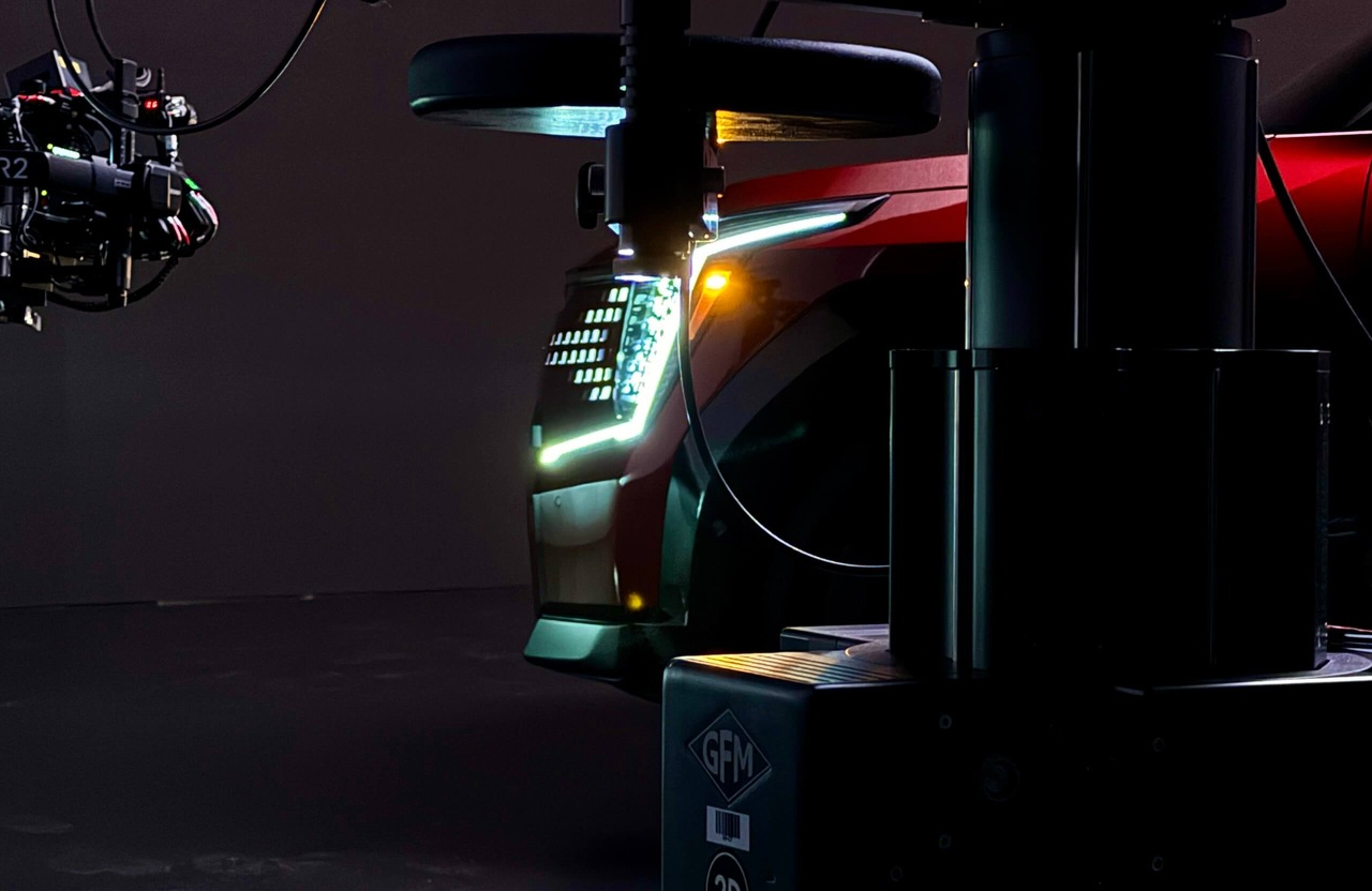 FX Productions Canada Close-up of a red car’s illuminated headlight and front corner, with filming equipment visible in the foreground. Toronto Video Production Company