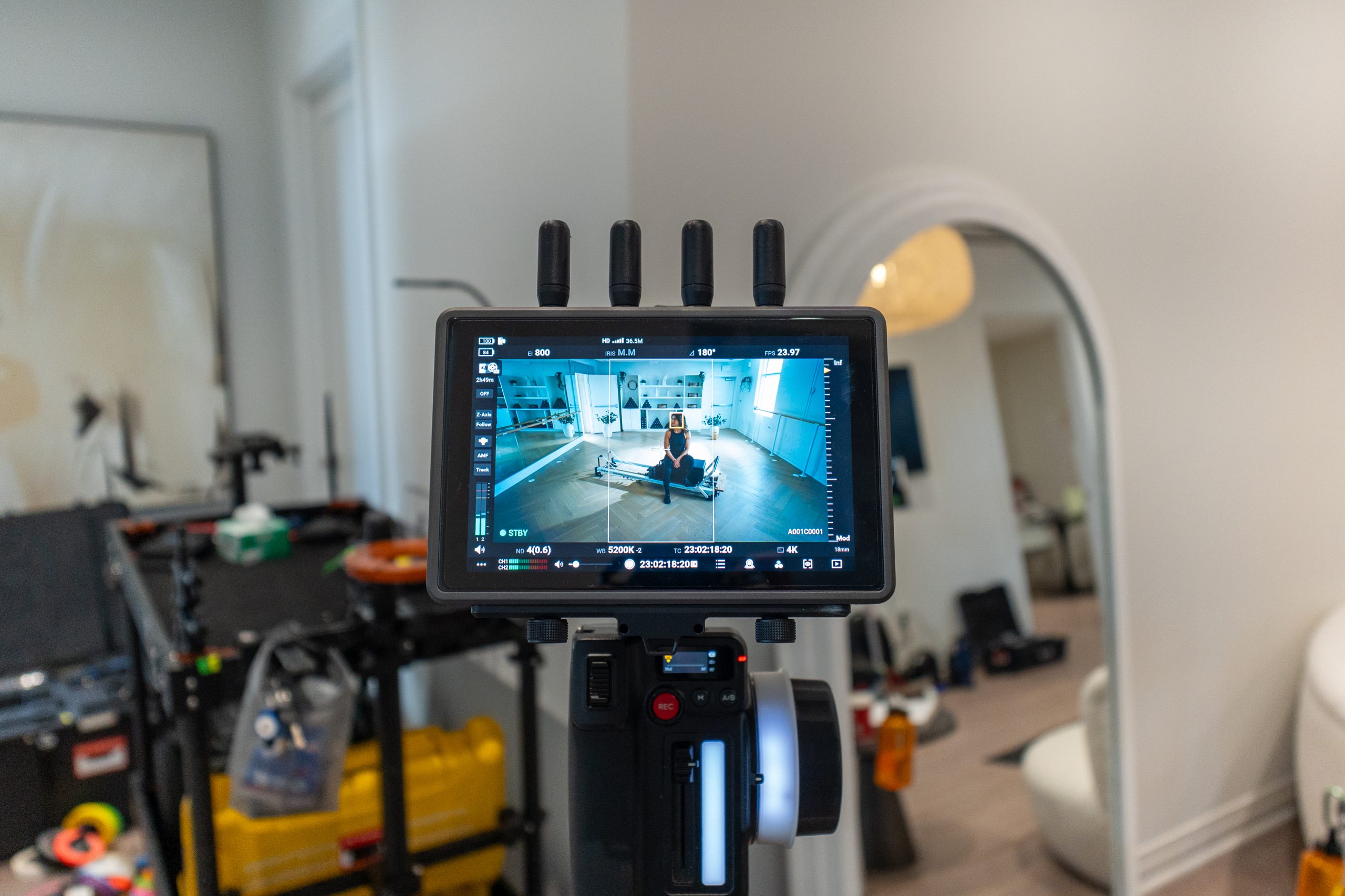 FX Productions Canada A video camera monitor displays a person sitting in a modern room with filming equipment visible in the background. Toronto Video Production Company