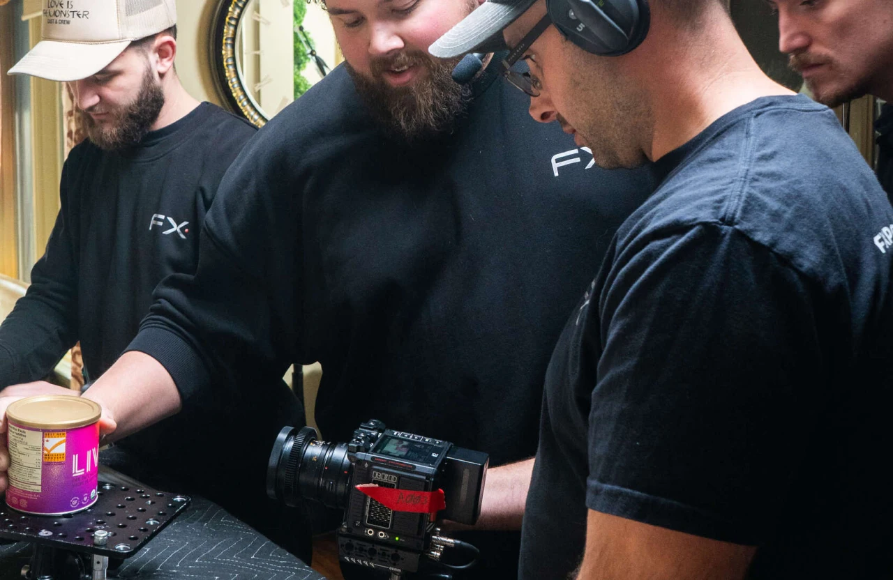 FX Productions Canada Four men in black shirts collaborate on a multi-location video production set, operating a professional camera, with one holding a container and another wearing a headset. Toronto Video Production Company