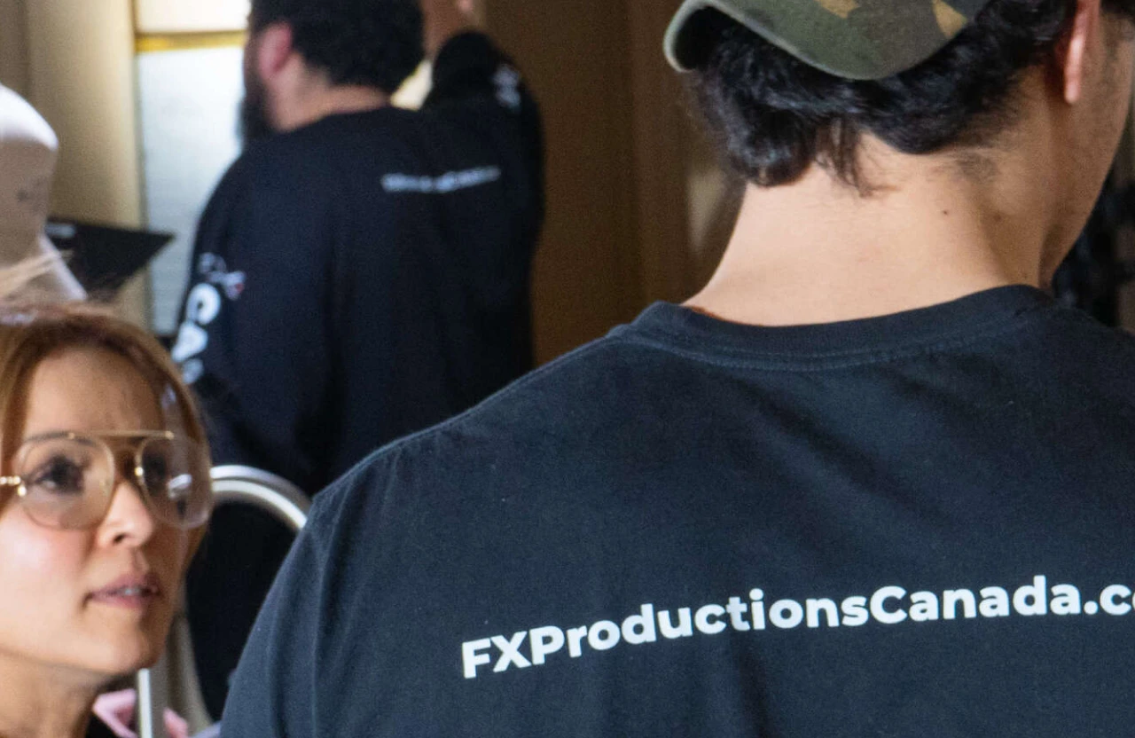 FX Productions Canada A person wearing a shirt with "FXProductionsCanada.com" printed on the back stands next to a woman with glasses, highlighting their low cost full service video production expertise. Toronto Video Production Company
