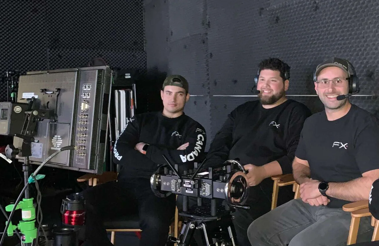 FX Productions Canada Three men sit behind a professional camera and monitor setup in a studio, wearing black shirts; one wears a headset. Toronto Video Production Company